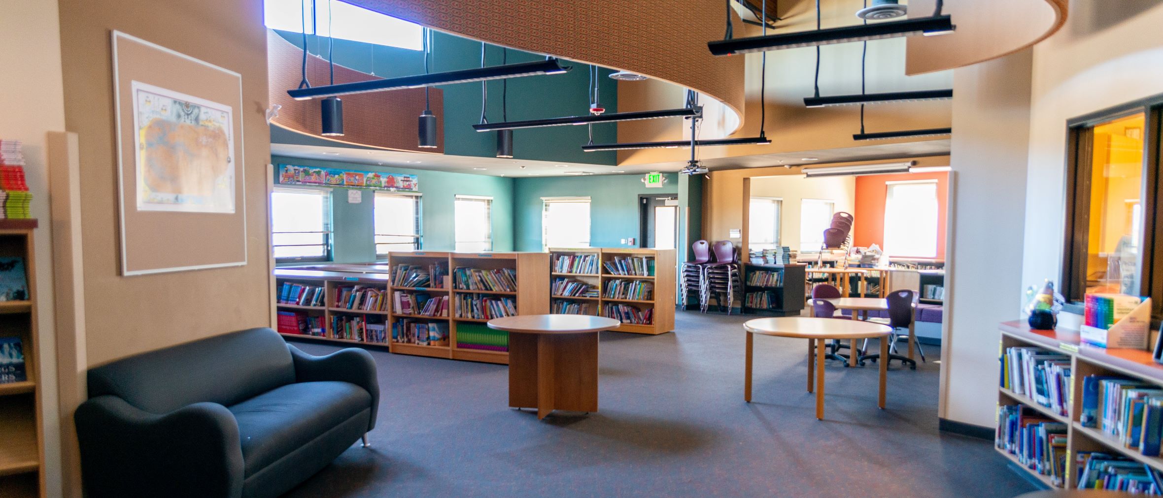 Light-filled library with bookshelves filled with books.