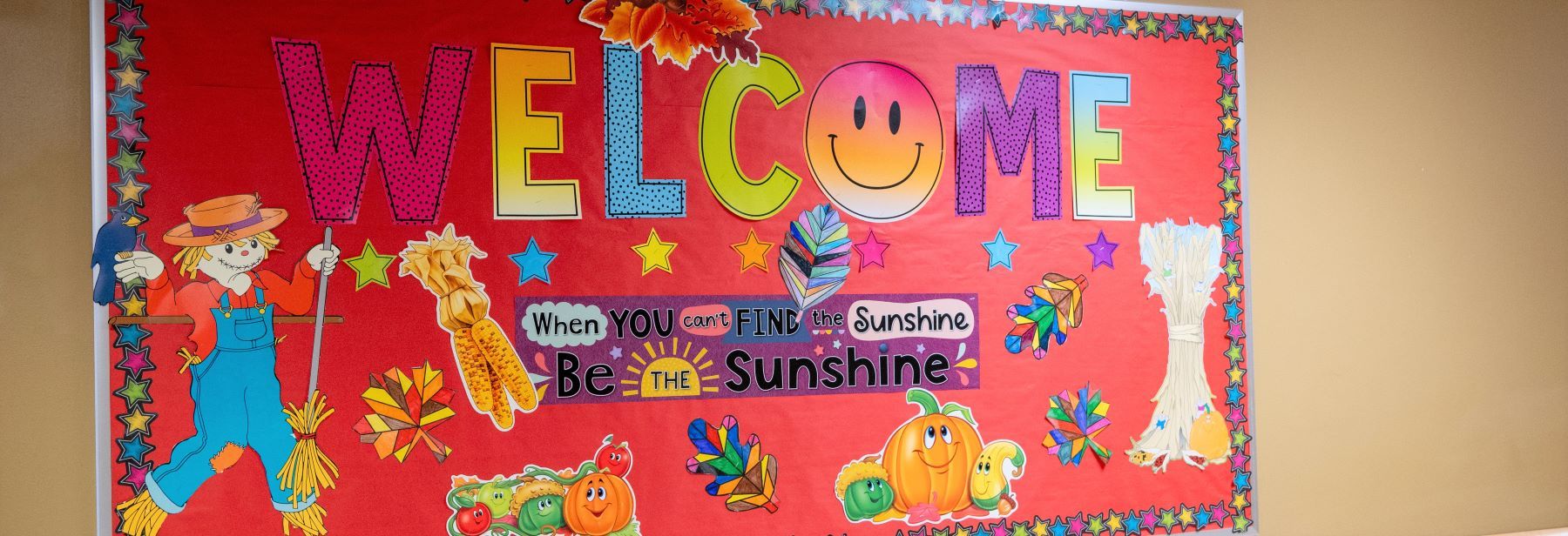 Bulletin board with a welcome sign in a school hallway, radiating warmth and inviting atmosphere.