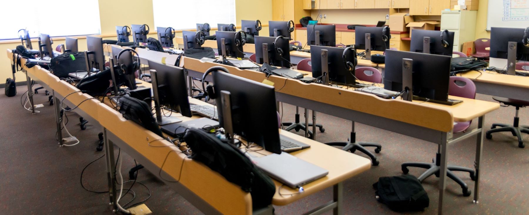 school room computer lab with lots of computers on tables