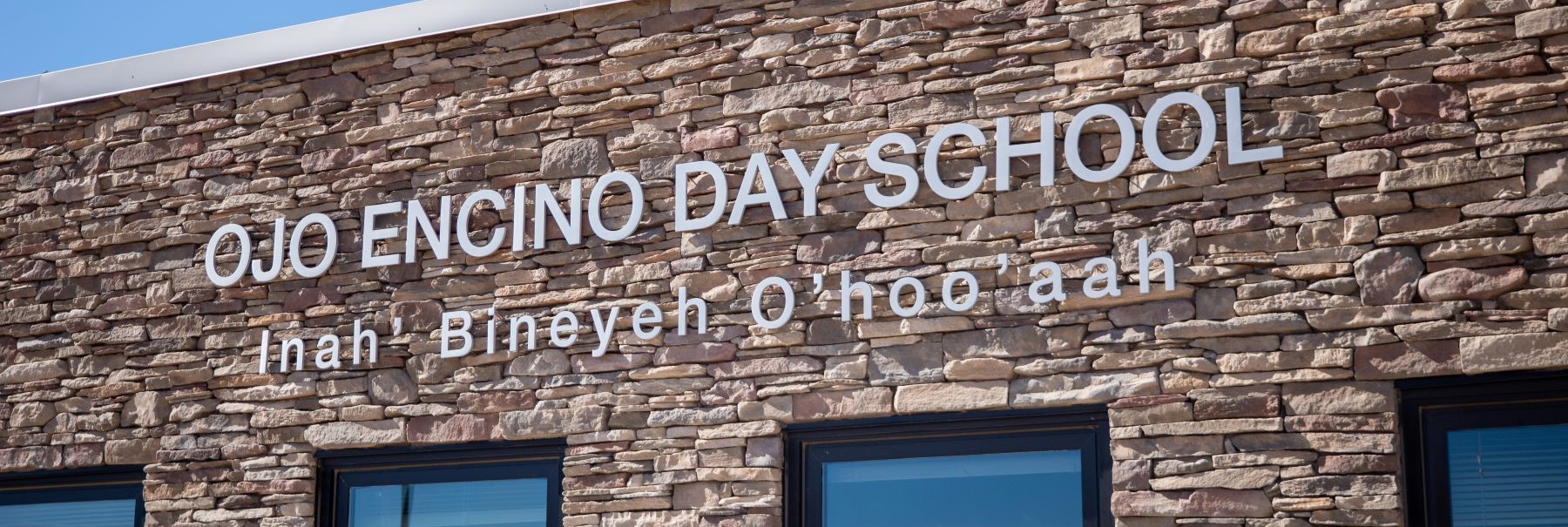 school lettering on building Ojo Encino Day School Iina' Biniye'O'hoo'aah